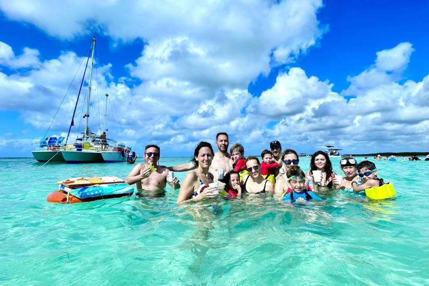 Catamaran anchored offshore with anglers and snorkelers onboard