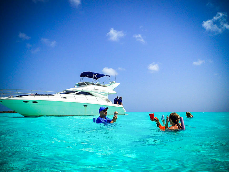 Small private beach with crystal-clear water and a yacht